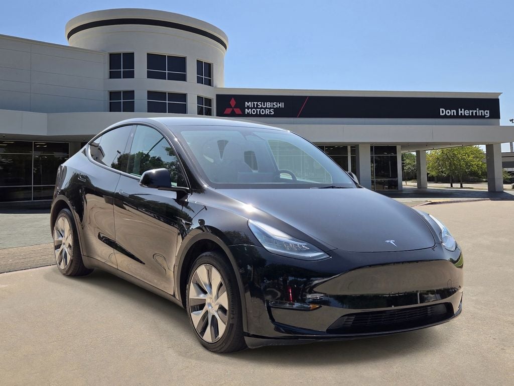2023 Tesla Model Y Long Range in Solid Black — front three-quarter view